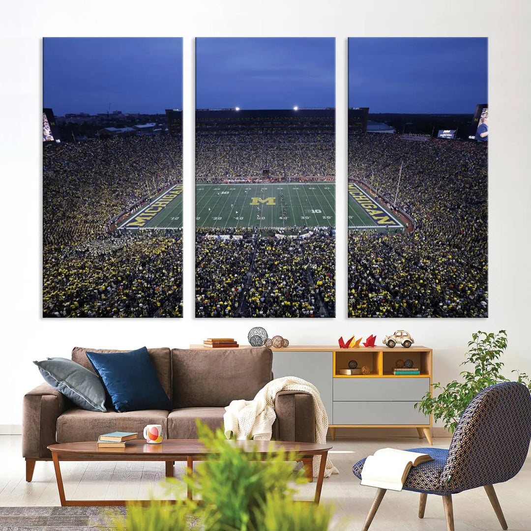 Experience the excitement and grandeur of a packed football stadium at night with this University of Michigan Wolverines Football Team Print. Featuring a panoramic view of the iconic Ann Arbor Michigan Stadium and its green field adorned with a large M logo, this canvas artwork offers a gallery-quality finish that brings an energetic moment into your space.