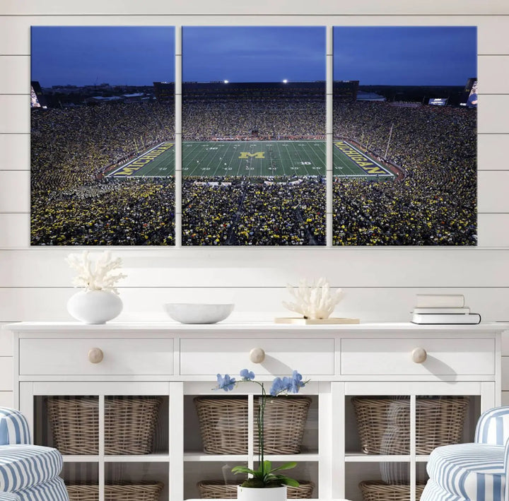 Experience the excitement and grandeur of a packed football stadium at night with this University of Michigan Wolverines Football Team Print. Featuring a panoramic view of the iconic Ann Arbor Michigan Stadium and its green field adorned with a large M logo, this canvas artwork offers a gallery-quality finish that brings an energetic moment into your space.