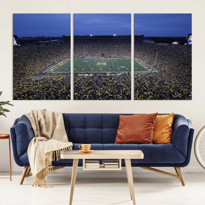 Experience the excitement and grandeur of a packed football stadium at night with this University of Michigan Wolverines Football Team Print. Featuring a panoramic view of the iconic Ann Arbor Michigan Stadium and its green field adorned with a large M logo, this canvas artwork offers a gallery-quality finish that brings an energetic moment into your space.