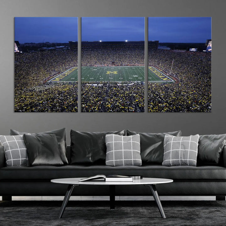 Experience the excitement and grandeur of a packed football stadium at night with this University of Michigan Wolverines Football Team Print. Featuring a panoramic view of the iconic Ann Arbor Michigan Stadium and its green field adorned with a large M logo, this canvas artwork offers a gallery-quality finish that brings an energetic moment into your space.