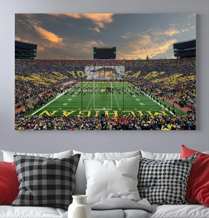 A living room showcases the University of Michigan Wolverines Football Team Print - Ann Arbor Michigan Stadium Wall Art Canvas Print in a triptych style. This stunning piece features a gallery-quality finish on premium canvas, infusing elegance into the space.