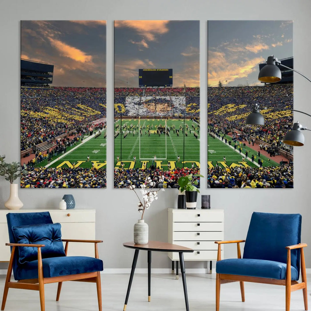 A living room showcases the University of Michigan Wolverines Football Team Print - Ann Arbor Michigan Stadium Wall Art Canvas Print in a triptych style. This stunning piece features a gallery-quality finish on premium canvas, infusing elegance into the space.