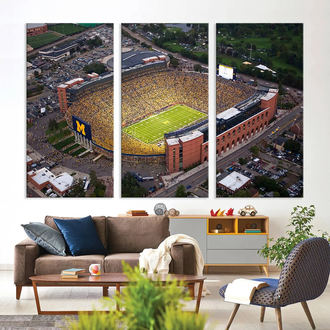 An aerial view of a packed football stadium featuring the University of Michigan Wolverines is beautifully captured on three panels of premium canvas wall art, handmade in the USA.