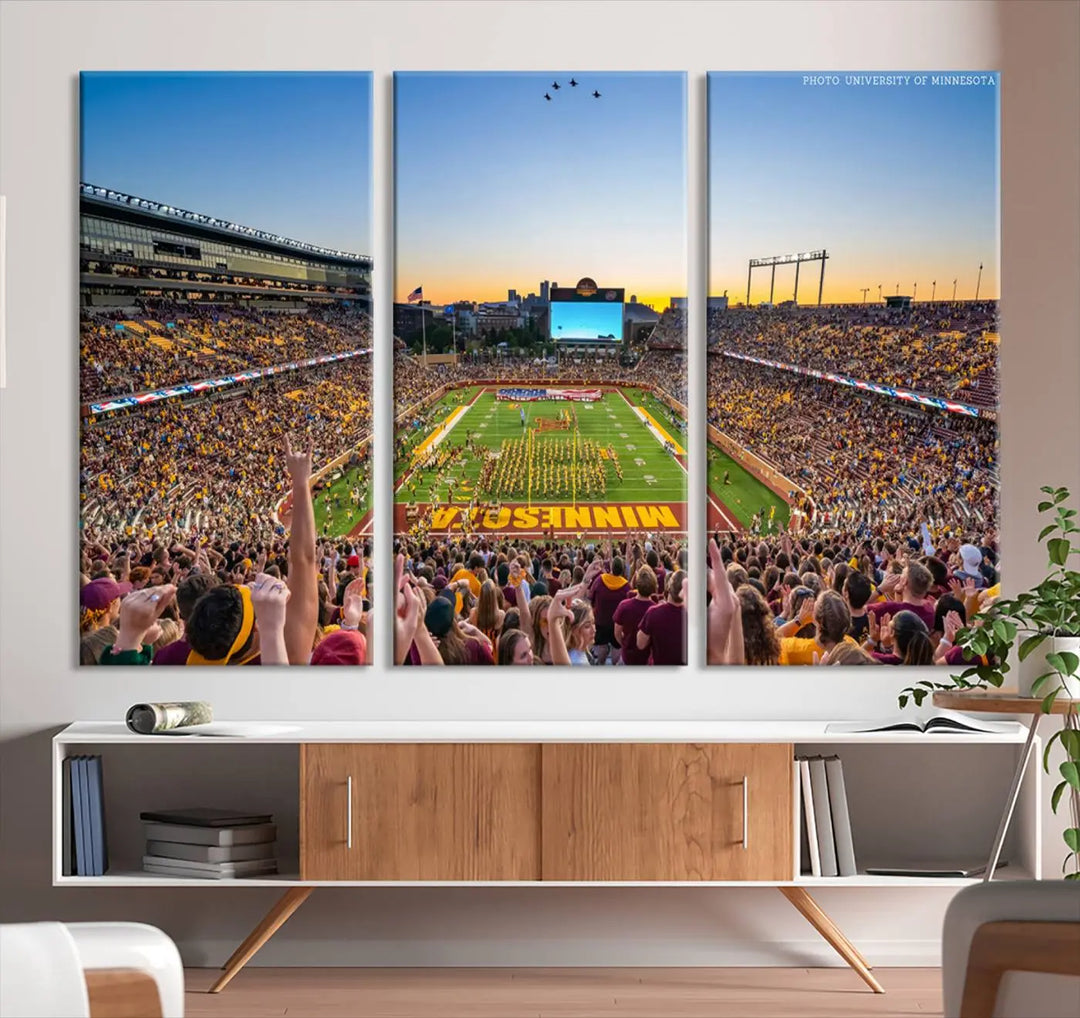 The University of Minnesota Golden Gophers Football Team Print captures the excitement of Minneapolis' Huntington Bank Stadium. This vibrant three-panel wall art showcases an enthusiastic crowd and a clear view of the field. Crafted on premium canvas with a gallery-quality finish, it transforms any space into an exhilarating sports sanctuary.