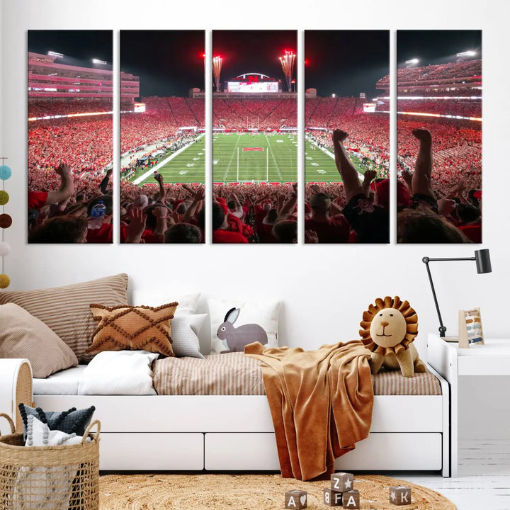 The University of Nebraska Cornhuskers Football Team Print, a vibrant three-panel canvas depicting Lincoln Memorial Stadium filled with enthusiastic fans from the end zone perspective, features a gallery-quality finish.