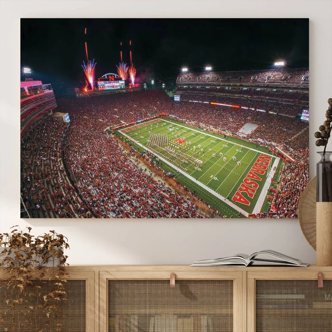 The University of Nebraska Cornhuskers Football Team Print, featuring Lincoln Memorial Stadium in a vibrant triptych canvas with fireworks above and a gallery-quality finish, is elegantly displayed.