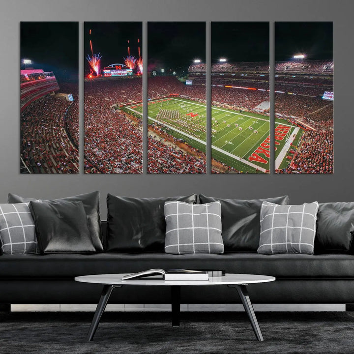 The University of Nebraska Cornhuskers Football Team Print, featuring Lincoln Memorial Stadium in a vibrant triptych canvas with fireworks above and a gallery-quality finish, is elegantly displayed.