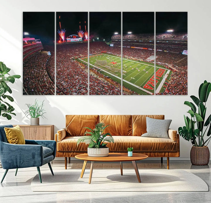 The University of Nebraska Cornhuskers Football Team Print, featuring Lincoln Memorial Stadium in a vibrant triptych canvas with fireworks above and a gallery-quality finish, is elegantly displayed.