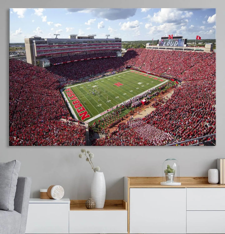 The University of Nebraska Cornhuskers Football Team Print showcases a vibrant triptych of Lincoln Memorial Stadium, depicting a packed football stadium filled with energetic fans. This handmade art piece is crafted in the USA and printed on premium canvas for a gallery-quality finish.