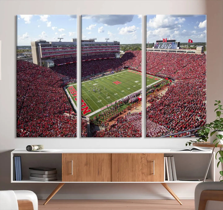 The University of Nebraska Cornhuskers Football Team Print showcases a vibrant triptych of Lincoln Memorial Stadium, depicting a packed football stadium filled with energetic fans. This handmade art piece is crafted in the USA and printed on premium canvas for a gallery-quality finish.