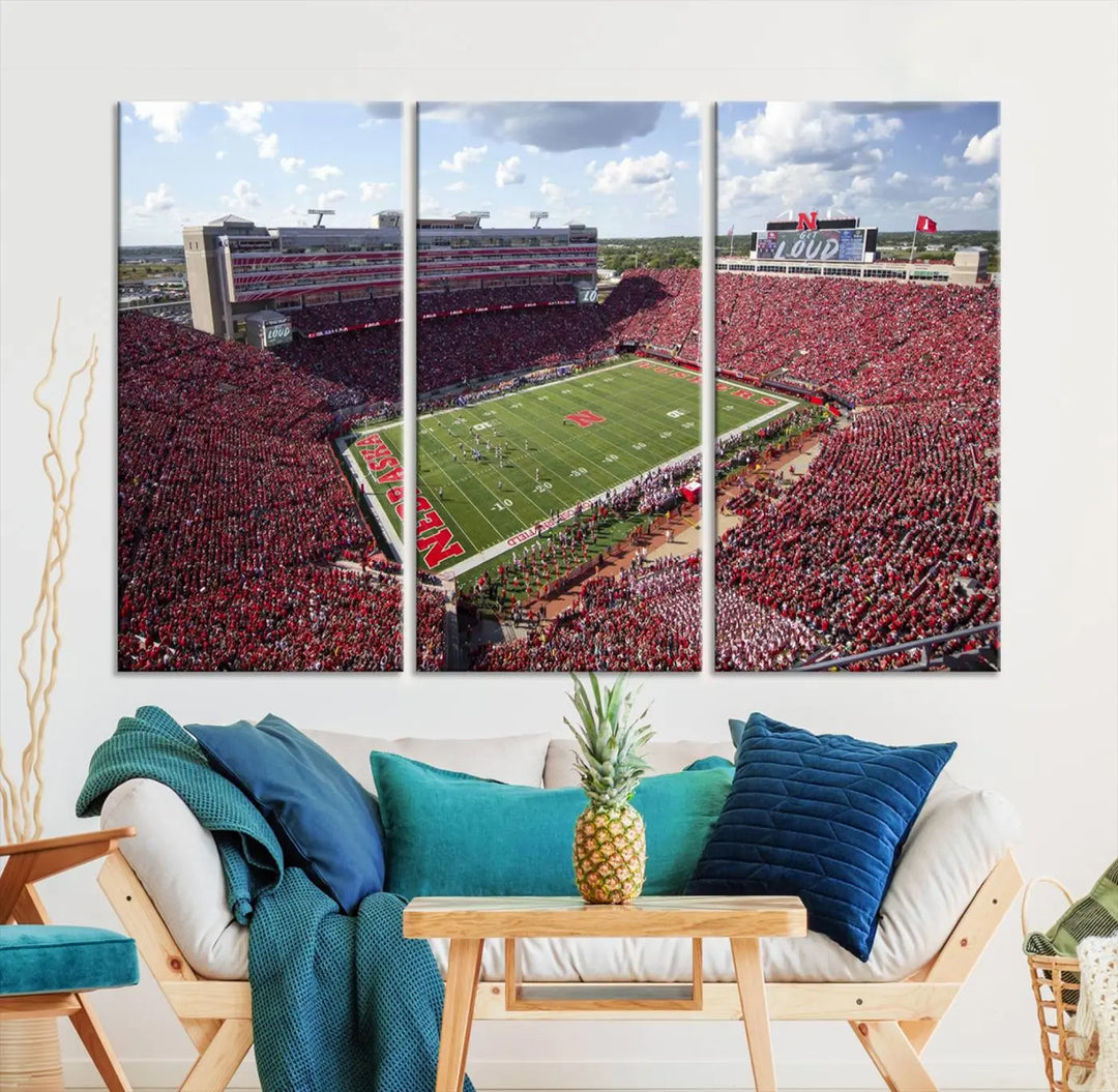 The University of Nebraska Cornhuskers Football Team Print showcases a vibrant triptych of Lincoln Memorial Stadium, depicting a packed football stadium filled with energetic fans. This handmade art piece is crafted in the USA and printed on premium canvas for a gallery-quality finish.