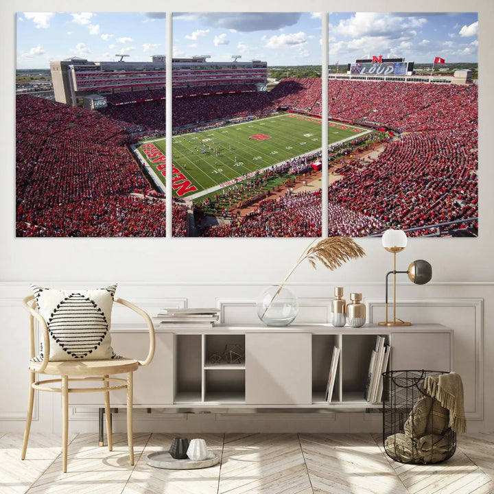 The University of Nebraska Cornhuskers Football Team Print showcases a vibrant triptych of Lincoln Memorial Stadium, depicting a packed football stadium filled with energetic fans. This handmade art piece is crafted in the USA and printed on premium canvas for a gallery-quality finish.