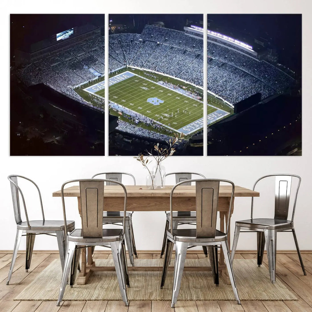 A University of North Carolina Tar Heels Football Team Print, showcasing Chapel Hill's Kenan Memorial Stadium, hangs in a modern dining room, adding a gallery-quality finish that enhances the entire space.