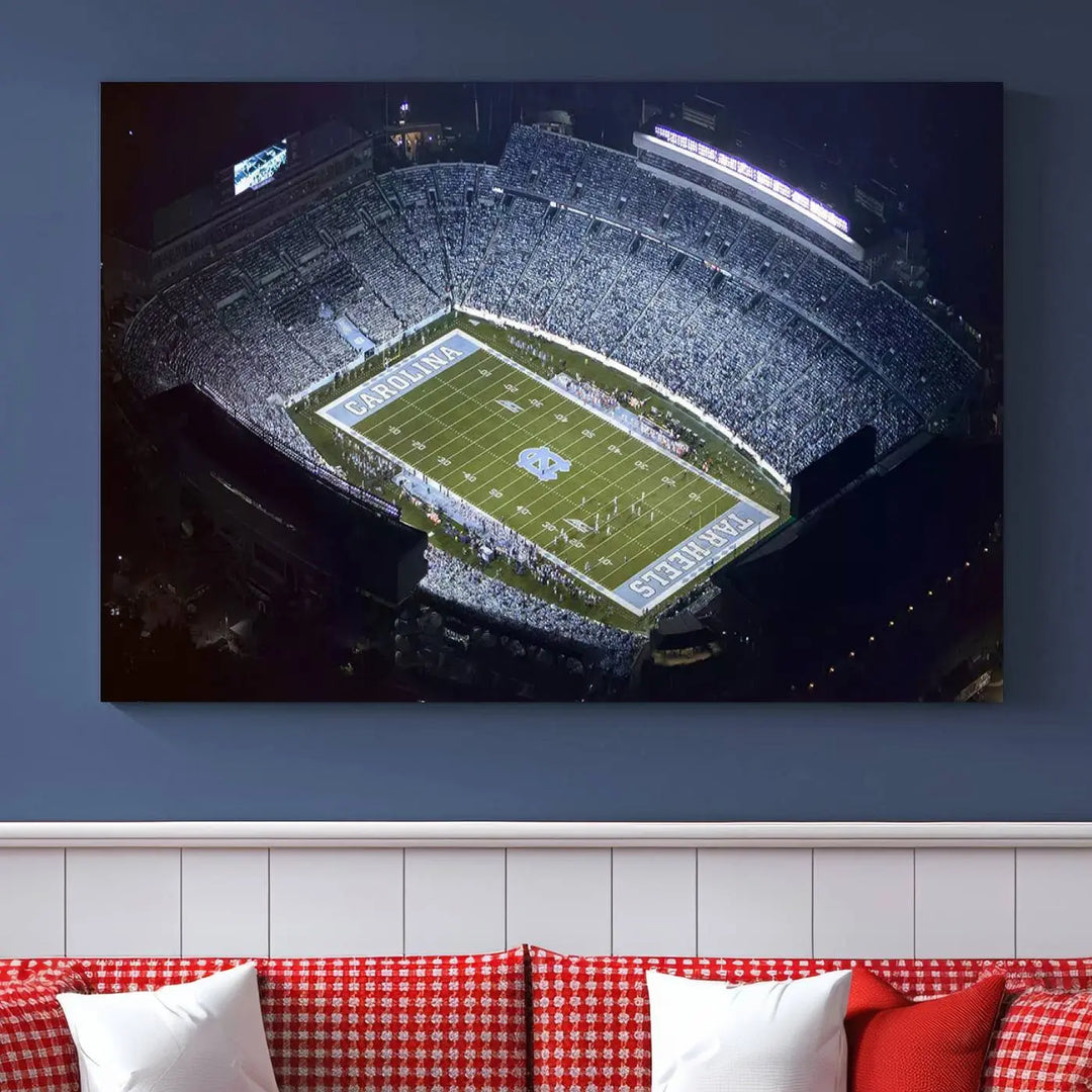 A University of North Carolina Tar Heels Football Team Print, showcasing Chapel Hill's Kenan Memorial Stadium, hangs in a modern dining room, adding a gallery-quality finish that enhances the entire space.