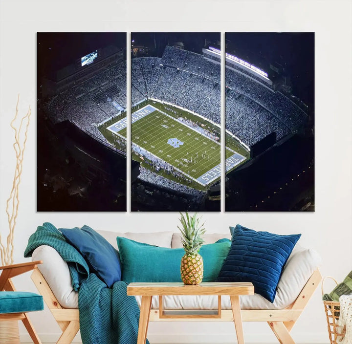 A University of North Carolina Tar Heels Football Team Print, showcasing Chapel Hill's Kenan Memorial Stadium, hangs in a modern dining room, adding a gallery-quality finish that enhances the entire space.