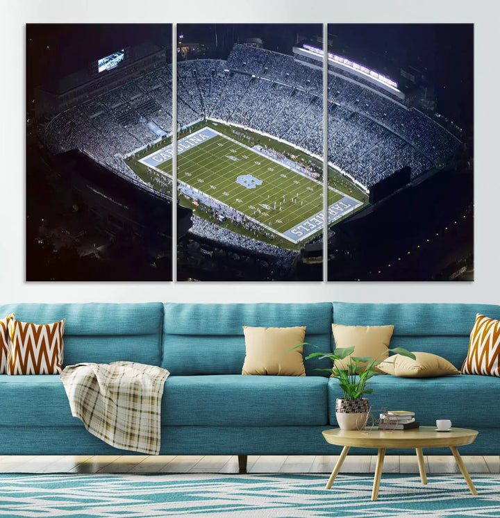 A University of North Carolina Tar Heels Football Team Print, showcasing Chapel Hill's Kenan Memorial Stadium, hangs in a modern dining room, adding a gallery-quality finish that enhances the entire space.