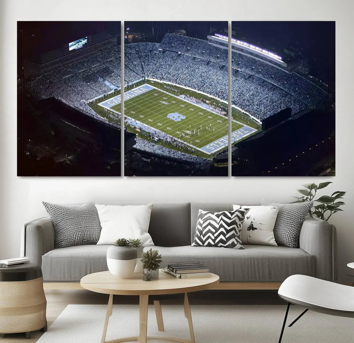 A University of North Carolina Tar Heels Football Team Print, showcasing Chapel Hill's Kenan Memorial Stadium, hangs in a modern dining room, adding a gallery-quality finish that enhances the entire space.