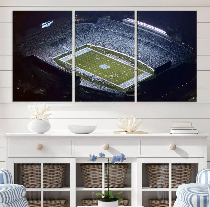 A University of North Carolina Tar Heels Football Team Print, showcasing Chapel Hill's Kenan Memorial Stadium, hangs in a modern dining room, adding a gallery-quality finish that enhances the entire space.