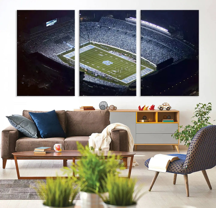 A University of North Carolina Tar Heels Football Team Print, showcasing Chapel Hill's Kenan Memorial Stadium, hangs in a modern dining room, adding a gallery-quality finish that enhances the entire space.