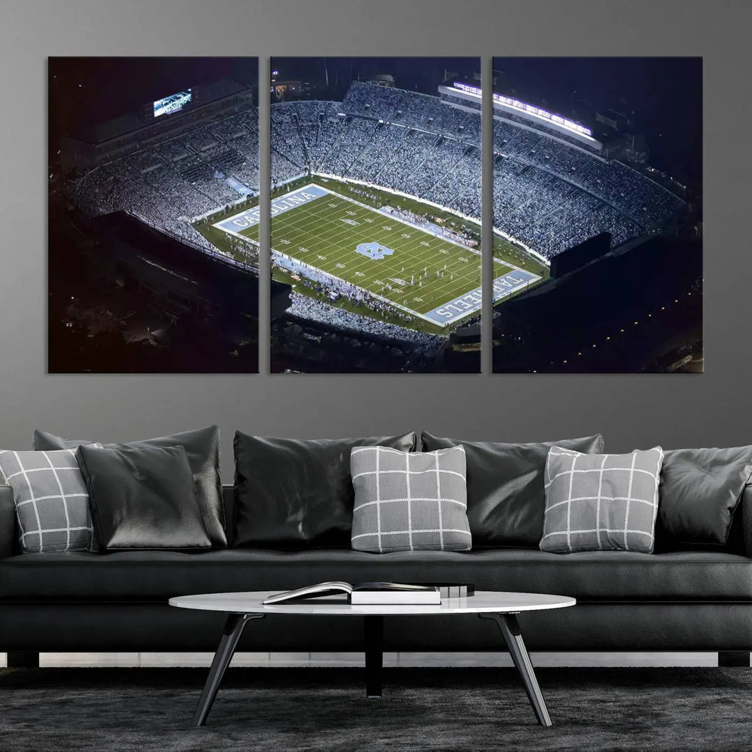 A University of North Carolina Tar Heels Football Team Print, showcasing Chapel Hill's Kenan Memorial Stadium, hangs in a modern dining room, adding a gallery-quality finish that enhances the entire space.