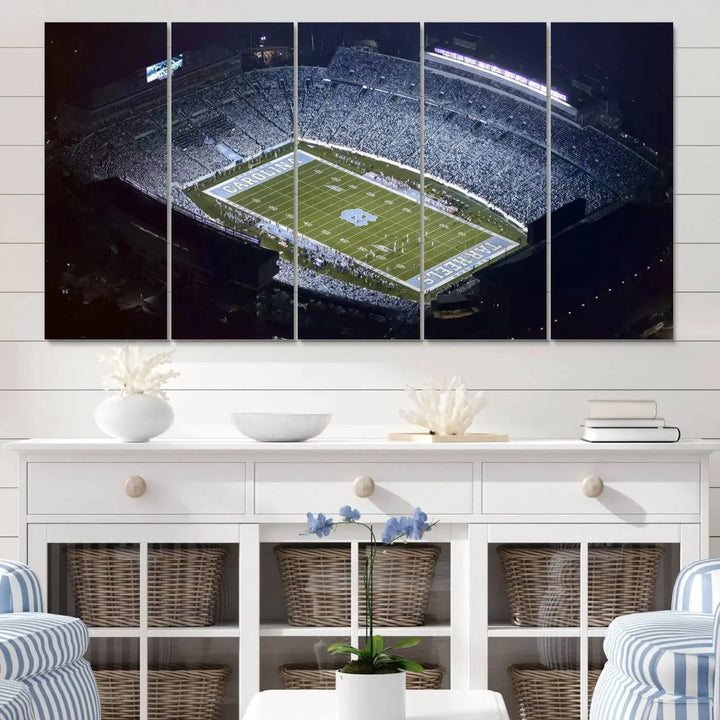 A University of North Carolina Tar Heels Football Team Print, showcasing Chapel Hill's Kenan Memorial Stadium, hangs in a modern dining room, adding a gallery-quality finish that enhances the entire space.