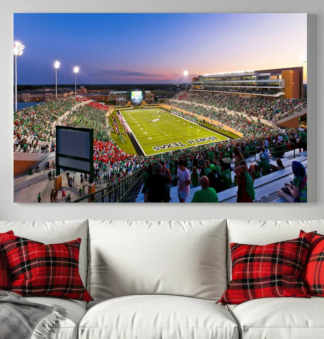 A panoramic triptych of the University of North Texas Mean Green Football Team in a packed Denton DATCU Stadium under evening lights, mounted as premium canvas wall art.