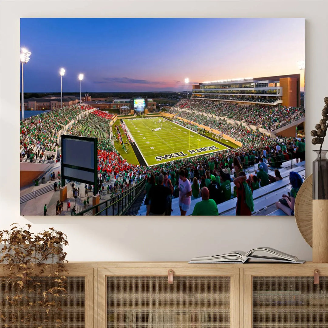 A panoramic triptych of the University of North Texas Mean Green Football Team in a packed Denton DATCU Stadium under evening lights, mounted as premium canvas wall art.