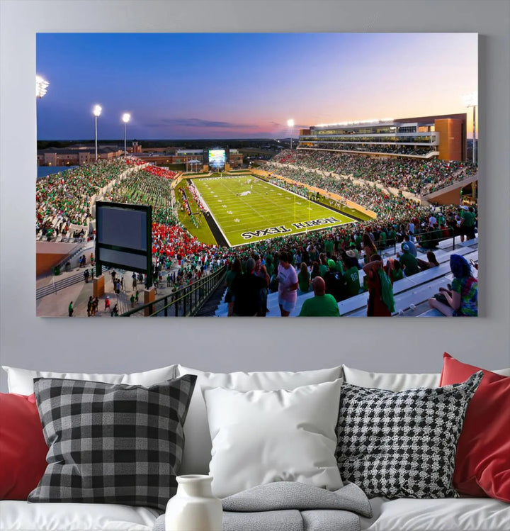 A panoramic triptych of the University of North Texas Mean Green Football Team in a packed Denton DATCU Stadium under evening lights, mounted as premium canvas wall art.