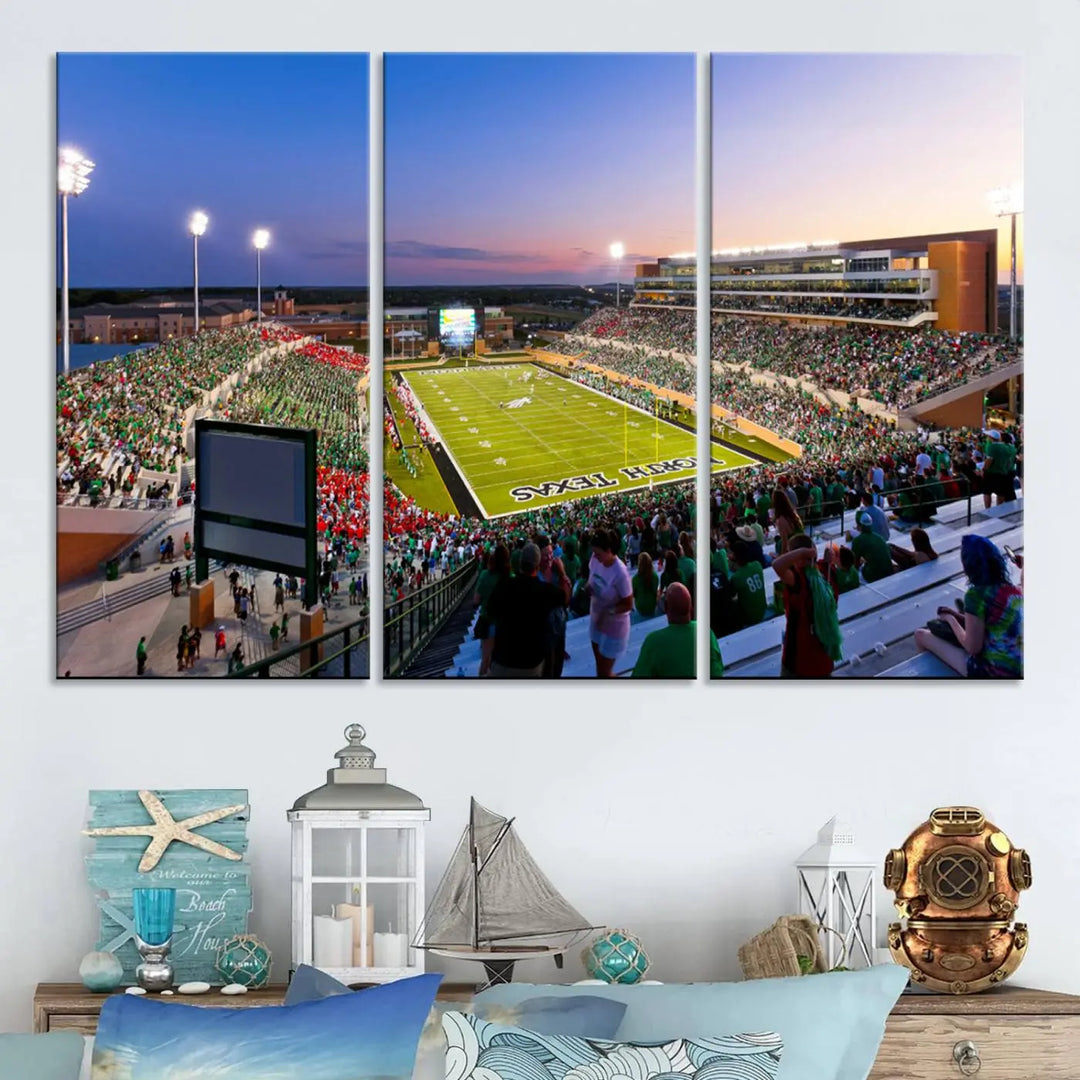 A panoramic triptych of the University of North Texas Mean Green Football Team in a packed Denton DATCU Stadium under evening lights, mounted as premium canvas wall art.