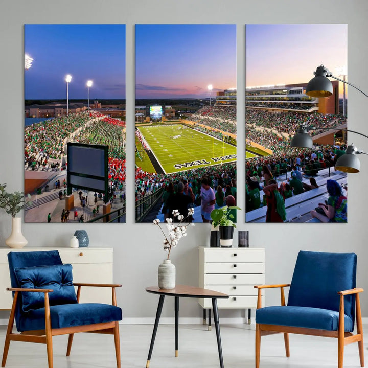 A panoramic triptych of the University of North Texas Mean Green Football Team in a packed Denton DATCU Stadium under evening lights, mounted as premium canvas wall art.