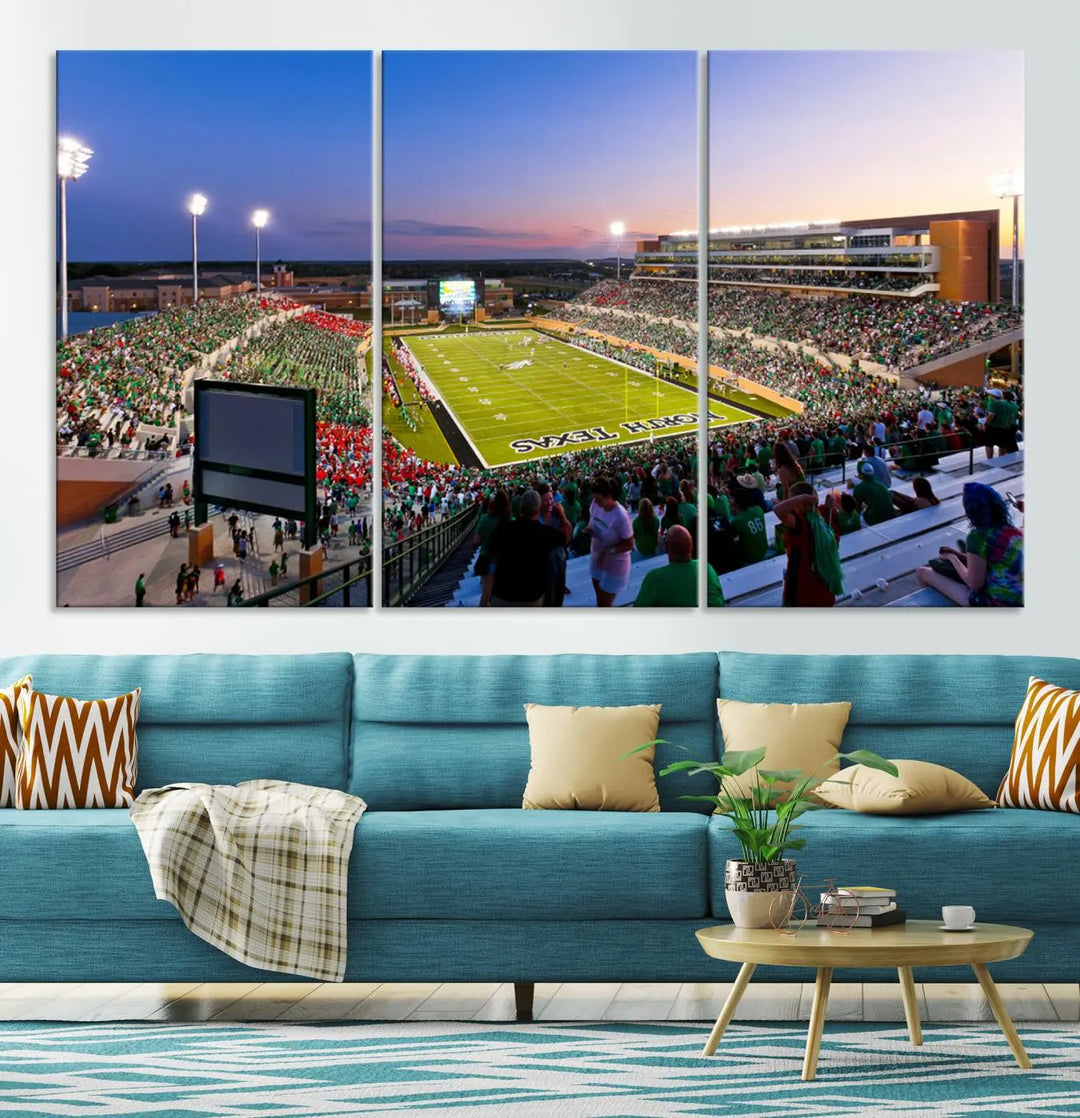 A panoramic triptych of the University of North Texas Mean Green Football Team in a packed Denton DATCU Stadium under evening lights, mounted as premium canvas wall art.