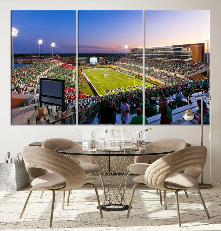 A panoramic triptych of the University of North Texas Mean Green Football Team in a packed Denton DATCU Stadium under evening lights, mounted as premium canvas wall art.