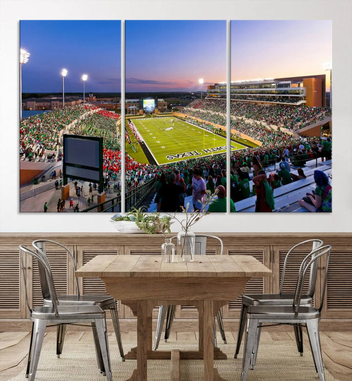 A panoramic triptych of the University of North Texas Mean Green Football Team in a packed Denton DATCU Stadium under evening lights, mounted as premium canvas wall art.