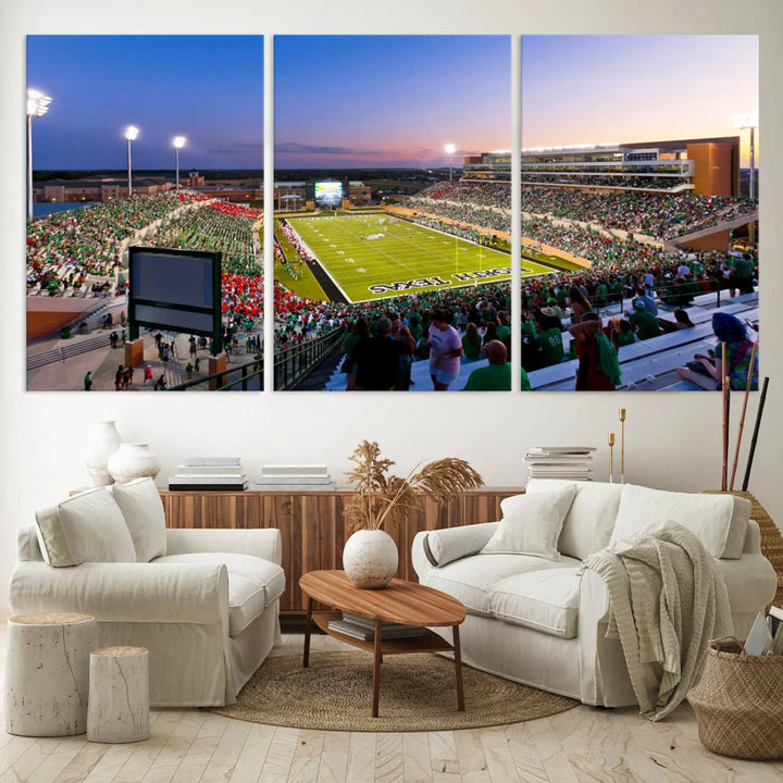 A panoramic triptych of the University of North Texas Mean Green Football Team in a packed Denton DATCU Stadium under evening lights, mounted as premium canvas wall art.