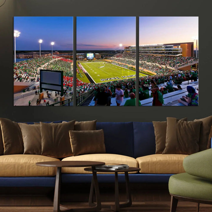 A panoramic triptych of the University of North Texas Mean Green Football Team in a packed Denton DATCU Stadium under evening lights, mounted as premium canvas wall art.