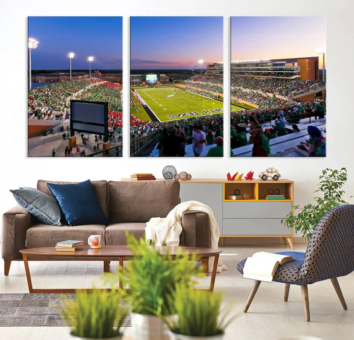 A panoramic triptych of the University of North Texas Mean Green Football Team in a packed Denton DATCU Stadium under evening lights, mounted as premium canvas wall art.