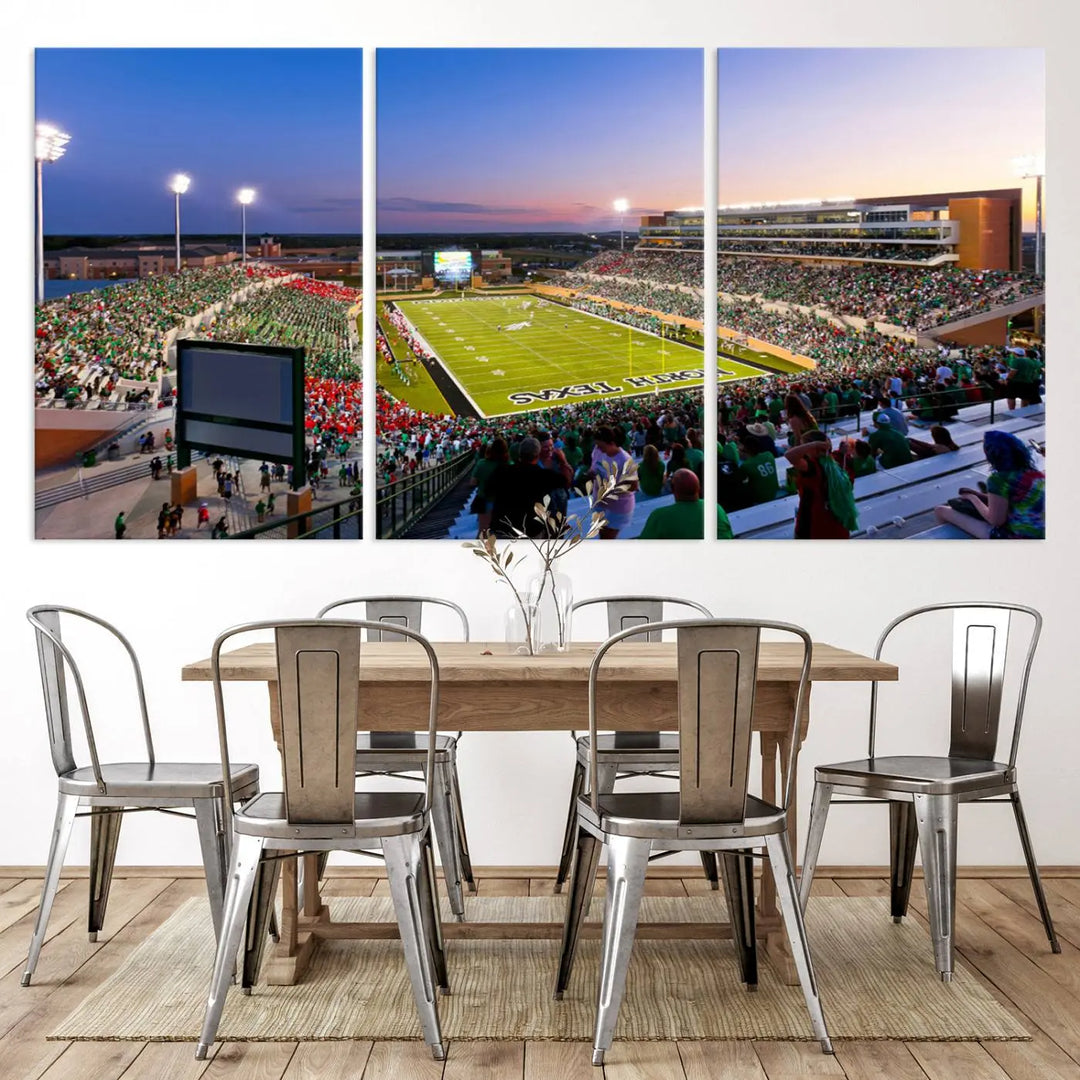 A panoramic triptych of the University of North Texas Mean Green Football Team in a packed Denton DATCU Stadium under evening lights, mounted as premium canvas wall art.