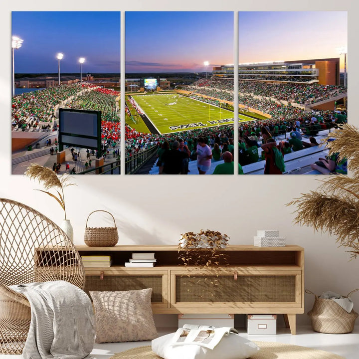 A panoramic triptych of the University of North Texas Mean Green Football Team in a packed Denton DATCU Stadium under evening lights, mounted as premium canvas wall art.