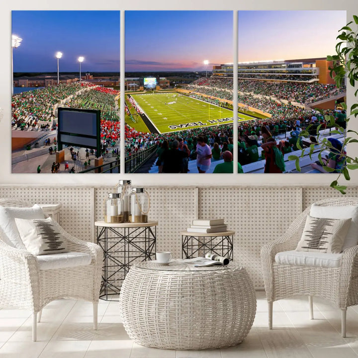 A panoramic triptych of the University of North Texas Mean Green Football Team in a packed Denton DATCU Stadium under evening lights, mounted as premium canvas wall art.