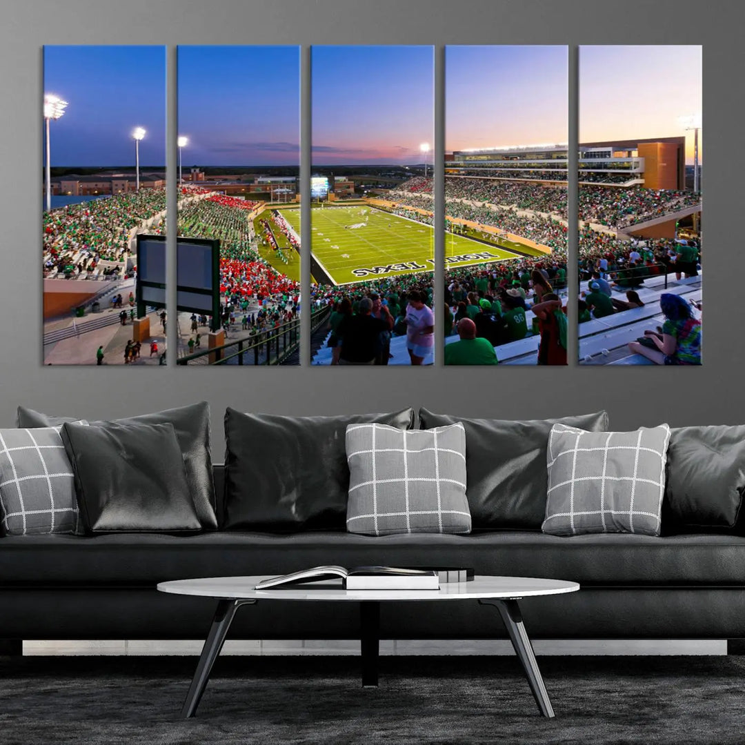 A panoramic triptych of the University of North Texas Mean Green Football Team in a packed Denton DATCU Stadium under evening lights, mounted as premium canvas wall art.