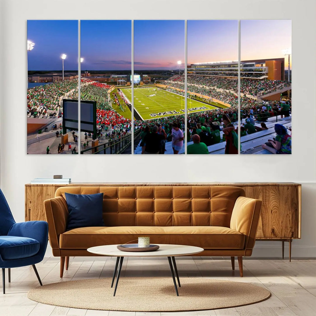 A panoramic triptych of the University of North Texas Mean Green Football Team in a packed Denton DATCU Stadium under evening lights, mounted as premium canvas wall art.