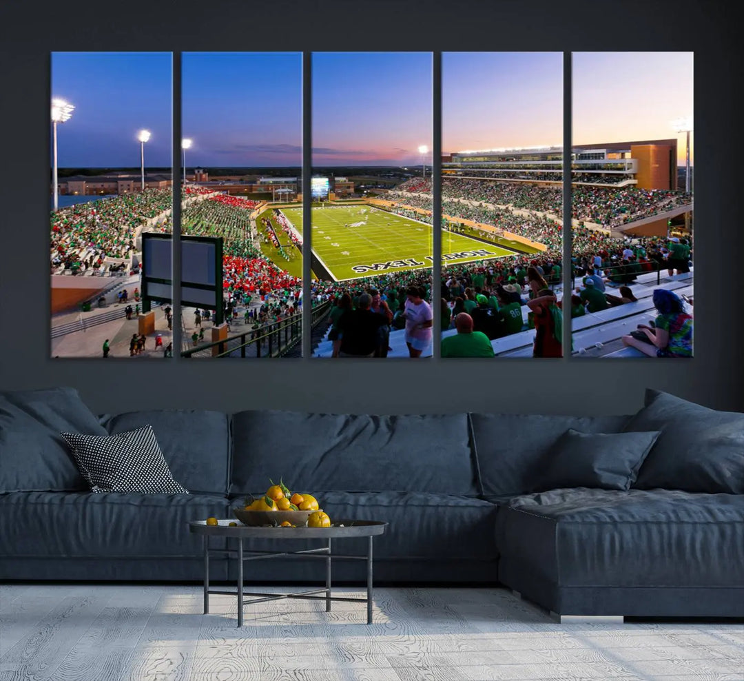 A panoramic triptych of the University of North Texas Mean Green Football Team in a packed Denton DATCU Stadium under evening lights, mounted as premium canvas wall art.