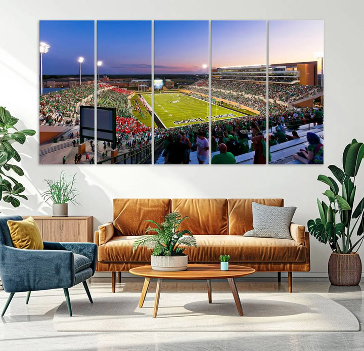 A panoramic triptych of the University of North Texas Mean Green Football Team in a packed Denton DATCU Stadium under evening lights, mounted as premium canvas wall art.