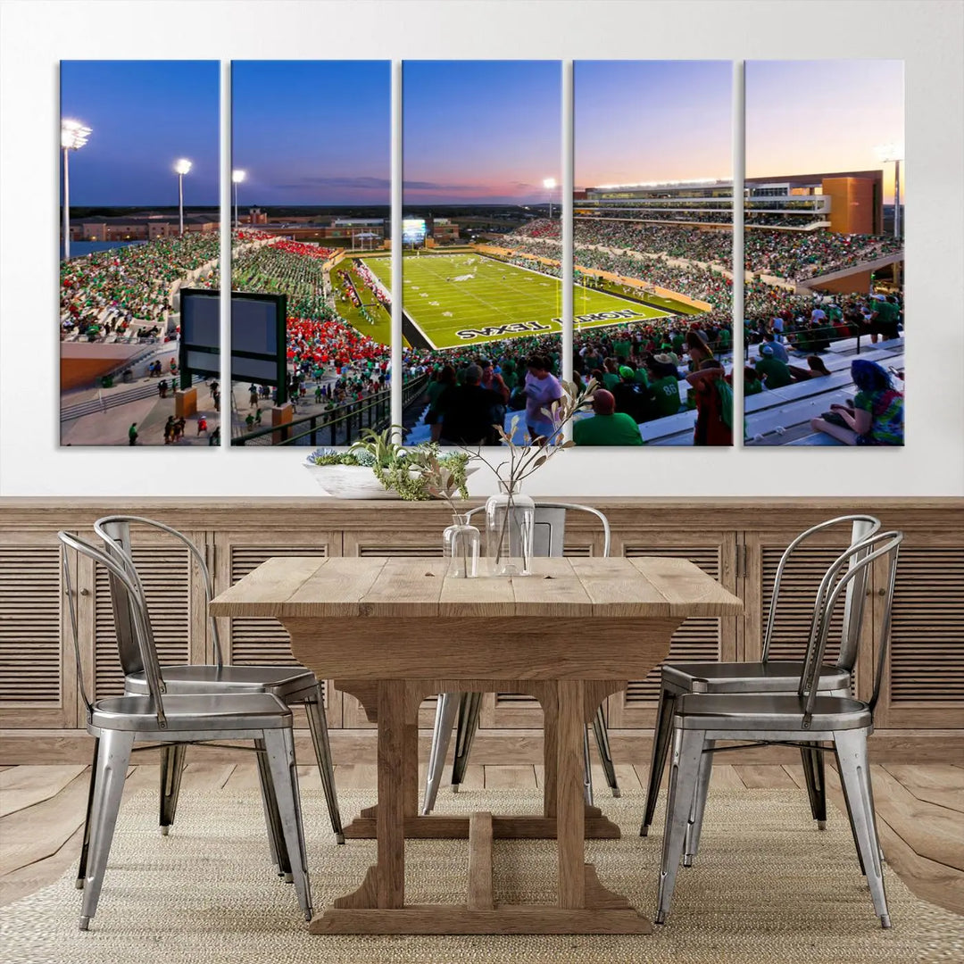 A panoramic triptych of the University of North Texas Mean Green Football Team in a packed Denton DATCU Stadium under evening lights, mounted as premium canvas wall art.