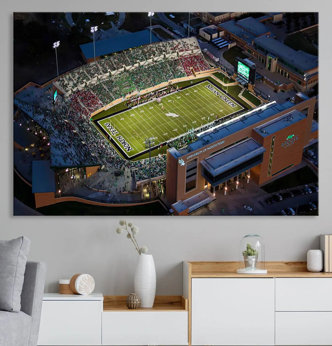 Aerial view of the University of North Texas Mean Green Football Team's DATCU Stadium at night, with packed stands, displayed on a premium canvas print as wall art.