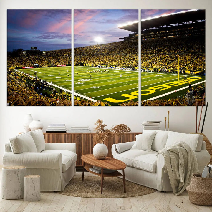 The living room showcases a triptych titled "University of Oregon Ducks Football Team Print - Eugene Autzen Stadium Wall Art Canvas Print," exhibiting a football stadium at sunset with a premium gallery-quality finish.