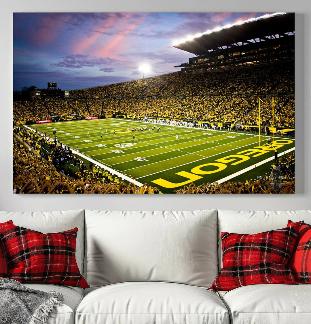 The living room showcases a triptych titled "University of Oregon Ducks Football Team Print - Eugene Autzen Stadium Wall Art Canvas Print," exhibiting a football stadium at sunset with a premium gallery-quality finish.