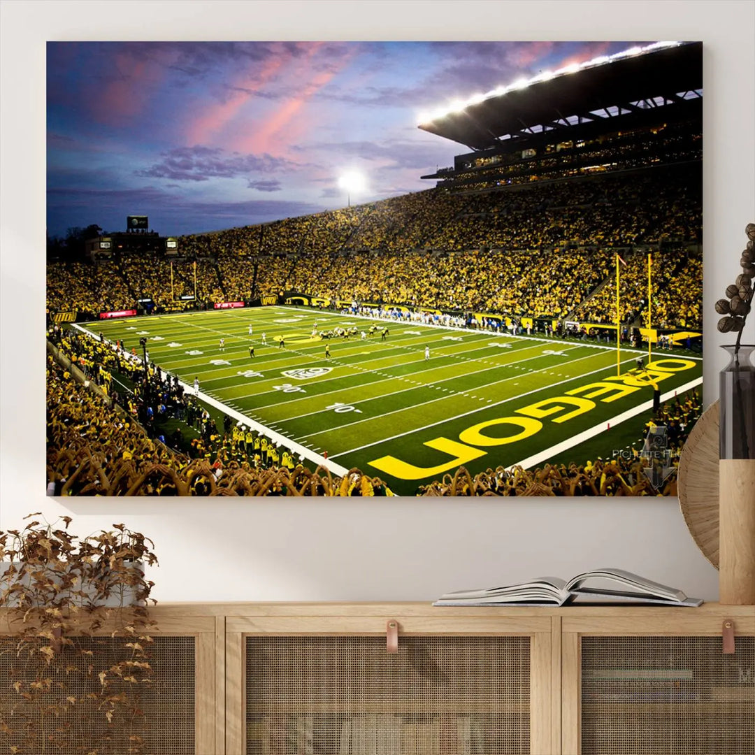 The living room showcases a triptych titled "University of Oregon Ducks Football Team Print - Eugene Autzen Stadium Wall Art Canvas Print," exhibiting a football stadium at sunset with a premium gallery-quality finish.