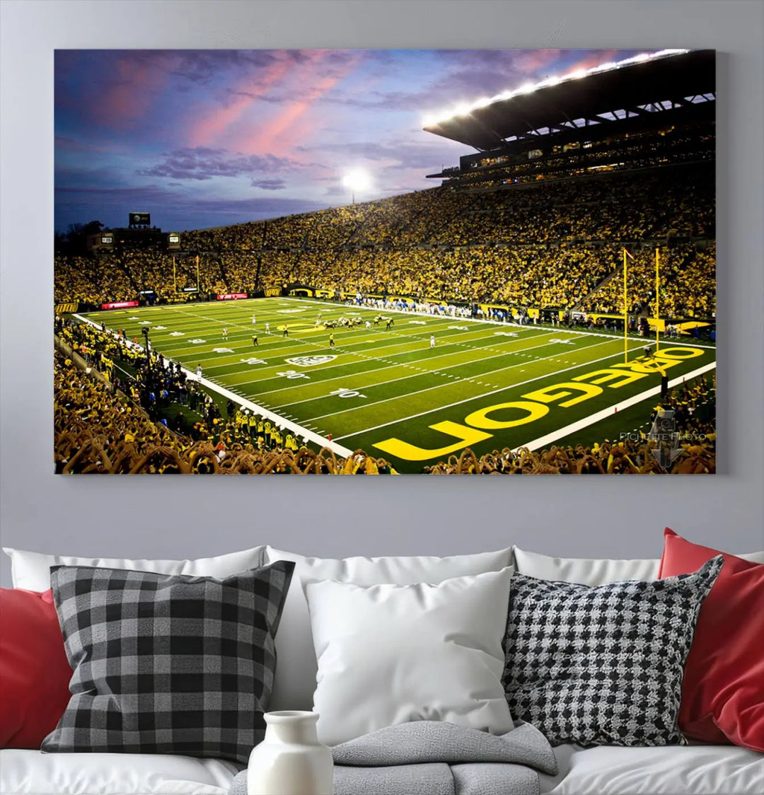 The living room showcases a triptych titled "University of Oregon Ducks Football Team Print - Eugene Autzen Stadium Wall Art Canvas Print," exhibiting a football stadium at sunset with a premium gallery-quality finish.