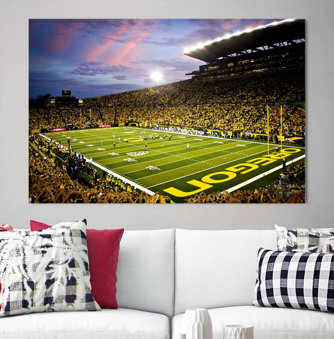 The living room showcases a triptych titled "University of Oregon Ducks Football Team Print - Eugene Autzen Stadium Wall Art Canvas Print," exhibiting a football stadium at sunset with a premium gallery-quality finish.